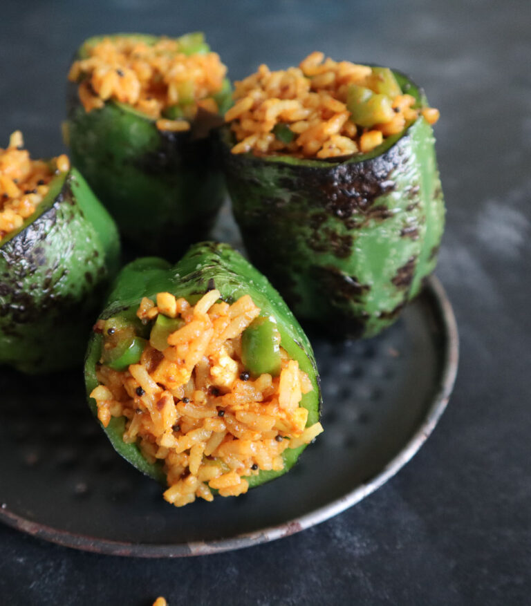 Leftover rice stuffed capsicum baked with Indian spices and served warm on a plate